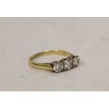 Diamond three stone ring with brilliants, approx. .3 and .5 ct in 18ct gold. Size P 1/2.