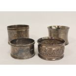 Two French silver napkin rings with engraved leafage inscribed and dated 1877 and another two