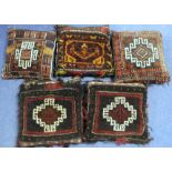 Five Afghan saddle bag cushions. (5).