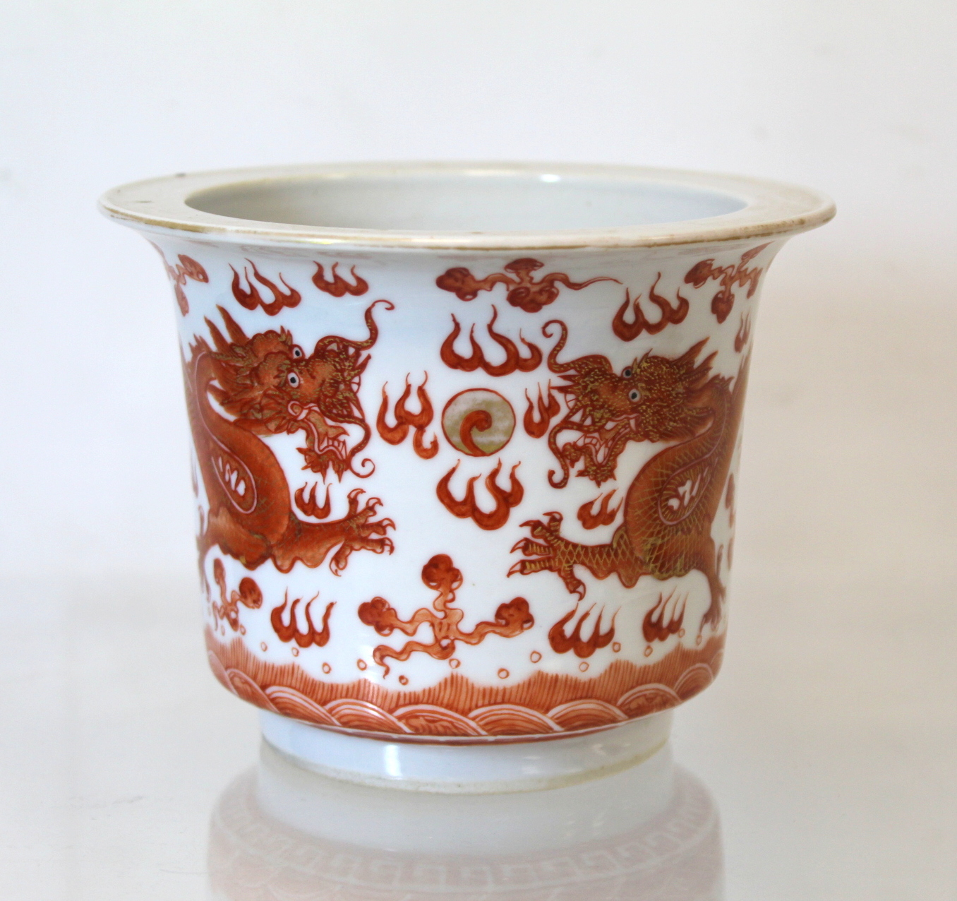 Small Chinese "Rouge de Fer" jardiniere or fern pot, decorated with dragons chasing flaming pearl.