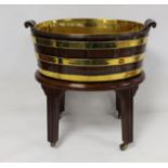 19th century mahogany brass bound planter of trim handled oval form, with removable brass liner,