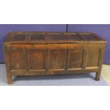 Antique oak coffer with five panel hinged top and front, on plain supports. 151cm long.