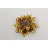 18ct gold brooch of tiered petalled form with diamond and sapphire stamens, import marks 1965.