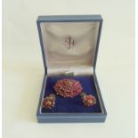 Victorian pyrope garnet oval cluster brooch in gold and a pair of similar earrings (3)