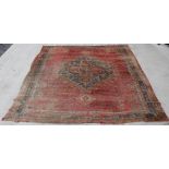 Large Persian wool carpet with central hexagonal hooked medallion in red and blue. 392cm x 356cm.