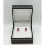 Pair of platinum and ruby and diamond studs. boxed