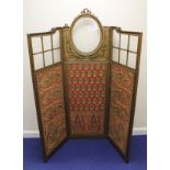 19th century gilt and upholstered ornate three fold dressing screen, the upper section with glazed