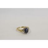 Diamond and sapphire oval cluster ring with eight cut brilliants in 18ct gold