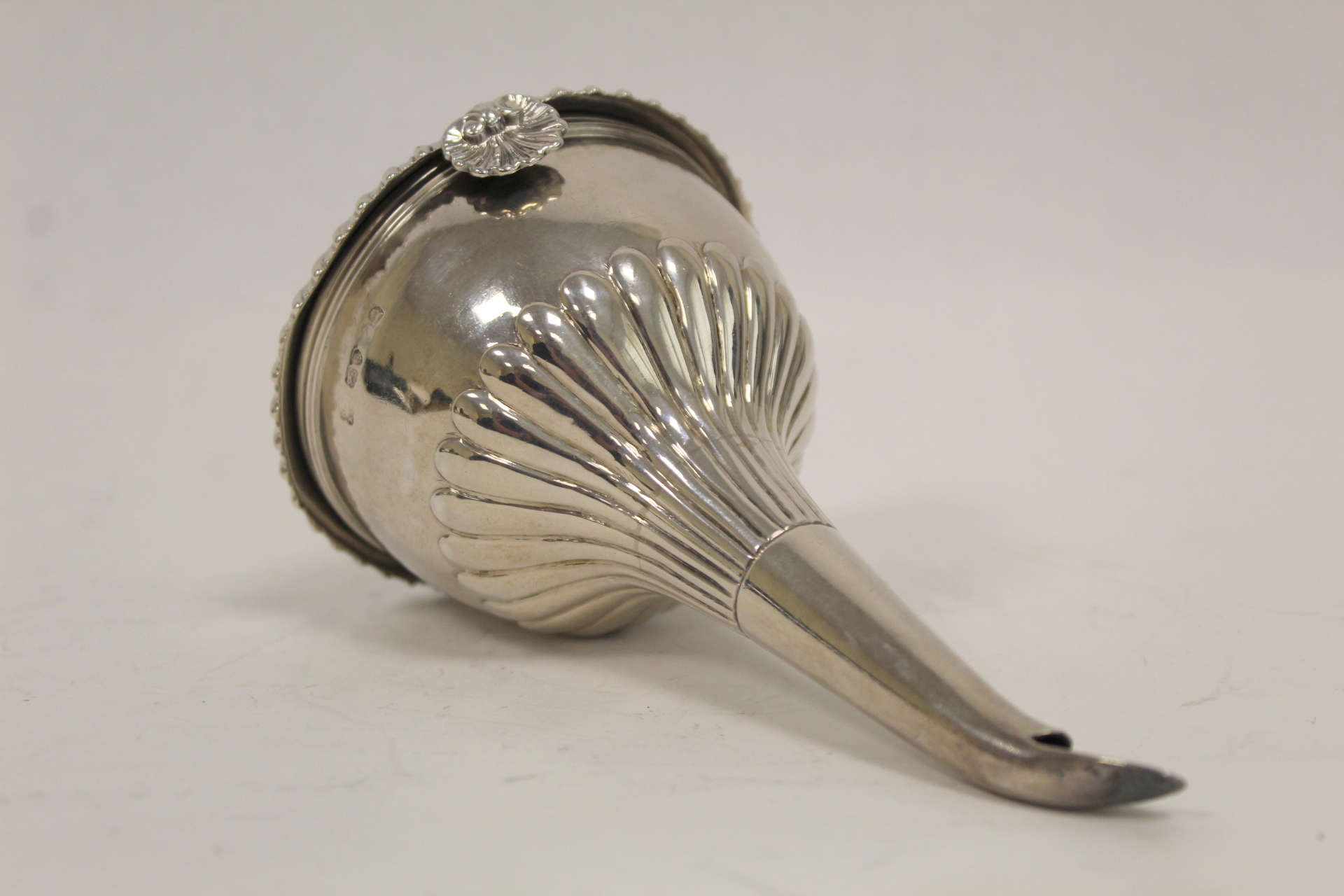 Silver wine funnel, part fluted with moulded edge, the cup with gadrooned edge, scallop grip and the