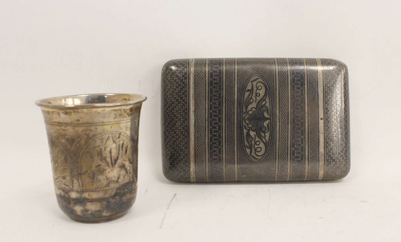 Silver and niello cigarette case, double hinged, probably Turkish and a Russian engraved tot, Moscow