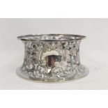 Irish silver 'potato ring' of typical spool shape embossed and pierced with flowers and scrolls,