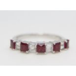 18ct white gold nine stone ruby and diamond ring. Princess cut rubies 0.76ct approx, Baguette cut