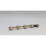 Edwardian graduated diamond bar brooch, unmarked but tests as 9ct gold. the five diamonds claw