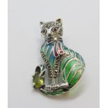 Silver brooch/pendant of a cat sitting with oval peridot, ruby eyes, marcasite and a plique-a-jour.