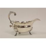 Silver sauce boat with flying scroll handle and waved edge on pad feet, by Robert Cox 1752, 5 1/2