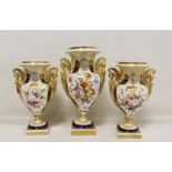 Garniture of three early 19th century porcelain vases of urn form, each with twin caryatid scroll