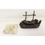 Cast bronze desk stand in the form of a small wooden fishing boat on a creek surrounded by tree