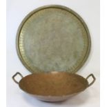 Antique Persian circular brass tray, 54cm diameter and a twin handled beaten copper Karahi or