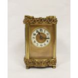 Late 19th century miniature carriage clock with sunken enamel dial. Gilded foliate borders with