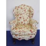 19th century mahogany framed upholstered wing chair with shaped apron on carved cabriole supports