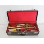 Vintage "Rudy Muck" brass trumpet in hard carry case. Various accessories and two mouthpieces.