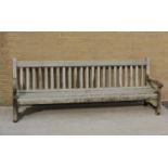 Large teak garden bench bearing label "Made by Hughes Bolokow, Ship breakers Company, Blyth,