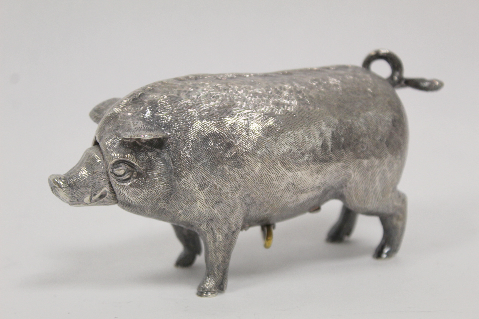 Good cast silver table bell, realistically modelled as a pig, with actuating snout and tail, by