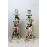 Pair of 19th century Continental porcelain figural candlesticks in the Meissen style depicting