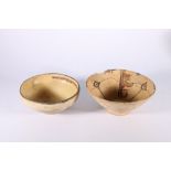 Two 18th century or earlier terracotta bowls probably Persian, with calligraphic decoration, the