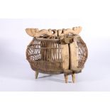 A double basketwork and carved wood bird cage, possibly Middle Eastern, with carved bird handles,