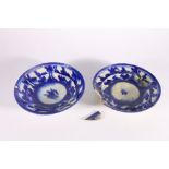 Two 18th or 19th century Iranian blue and white shallow bowls, with deep foot well and sylised