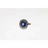 18ct gold sapphire and diamond ring, the sapphire approximately 10mm x 8mm encircled by twelve small