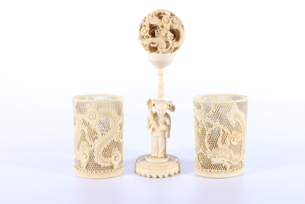 Chinese early 20th Century carved ivory ball in ball with figural supports, 18cm and two Chinese