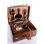 Early 20th century leather travel case, the fitted interior with silver topped toilet jars by Thomas