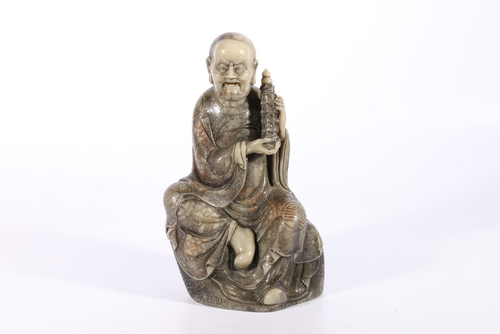 Large late 19th century Chinese soapstone carving of a bearded seated lohan holding a model of a