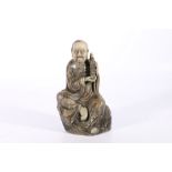 Large late 19th century Chinese soapstone carving of a bearded seated lohan holding a model of a