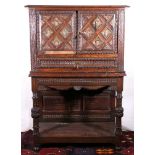 19th century Continental oak cabinet with carved frieze, the doors carved and painted with bust of