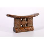 Carved wood neck rest possibly Zulu with chip carved and pierced central panel, 11 cm x 20cm.
