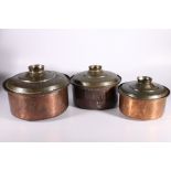 Group of three graduated Jordanian copper cooking vessels and covers, 23cm to 32cm wide (3)