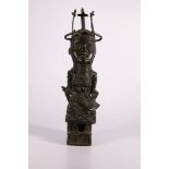 Early 20th century cast bronze Benin figure of a seated female holding an axe, with elaborate