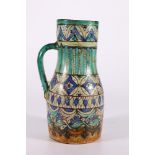 19th century Iznic jug, well decorated with geometric designs, blue glazed handle, 23cm, restored