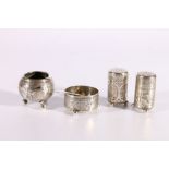 Four piece Persian silver cruet set with two pepperettes, a salt dish and a mustard, all on ball