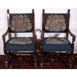 Pair of mahogany throne type chairs raised on X bases having lion mask terminals, upholstered in