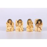 Four early 20th Century inked netsuke of dancing figures with rotating heads, 5cm.