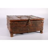 Indian wooden casket with hinged lid and carrying handle, metal banded with incised and carved