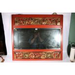 Bevelled mirror within a Chinese red lacquered and gilded carved wood frame, depicting figures in