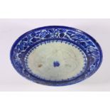 18th or 19th century Iranian blue and white shallow bowl with bands of floral decoration, 23cm