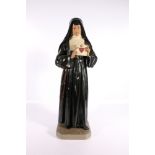 20th century plaster figure modelled as a nun, possibly Saint Margaret Mary Alacoque holding