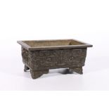 Late 19th century Chinese bronze censer of rectangular form on four short supports, the exterior