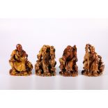 Set of four 20th Century Chinese soapstone carvings depicting seated Buddhist figures each with an